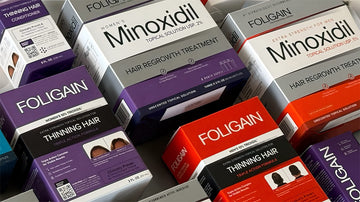 상자에 담긴 다양한 FOLIGAIN 미녹시딜 및 TRIOXIDIL 모발 케어 제품.